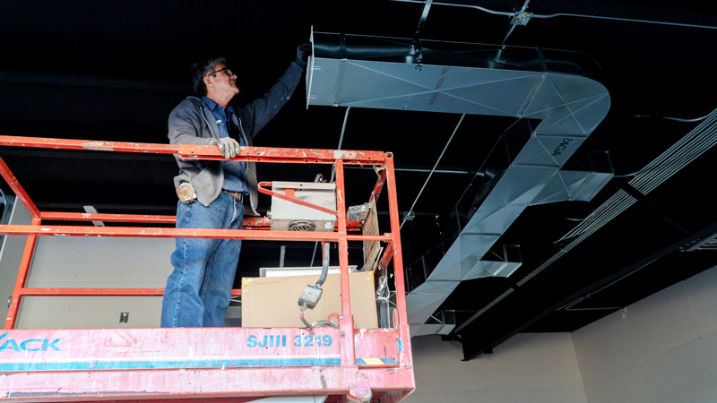 technician fixing ducts